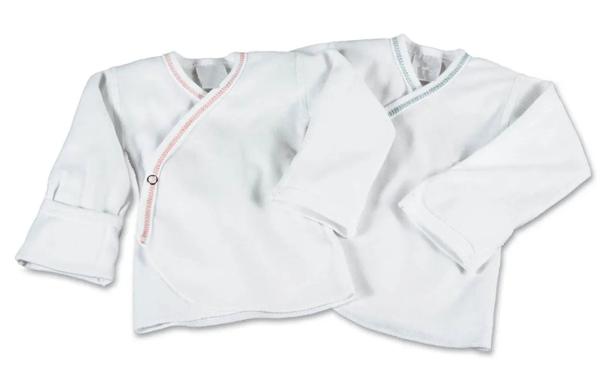 Two KSE Slip-Over Baby Shirts—long sleeve with mitten cuffs—are laid flat on a white background, one with pink trim and one with blue trim.