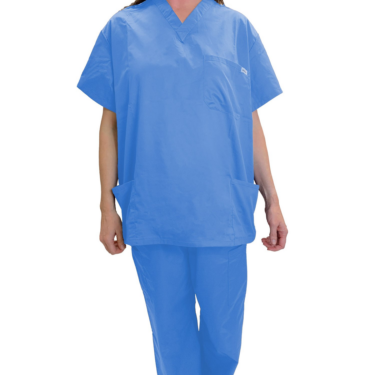 A person wears light blue Martex Health Classic Scrub Tops by WestPoint Home—unisex, short sleeves, two large front pockets, and made with antimicrobial SILVERbac technology—standing against a white background.