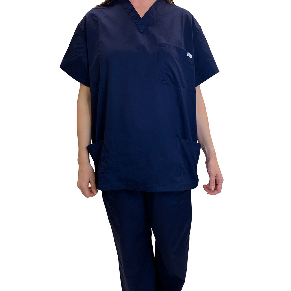 A person models WestPoint Homes Martex Health Classic Scrub Top in navy blue with SILVERbac technology against a white background, with their face not visible.