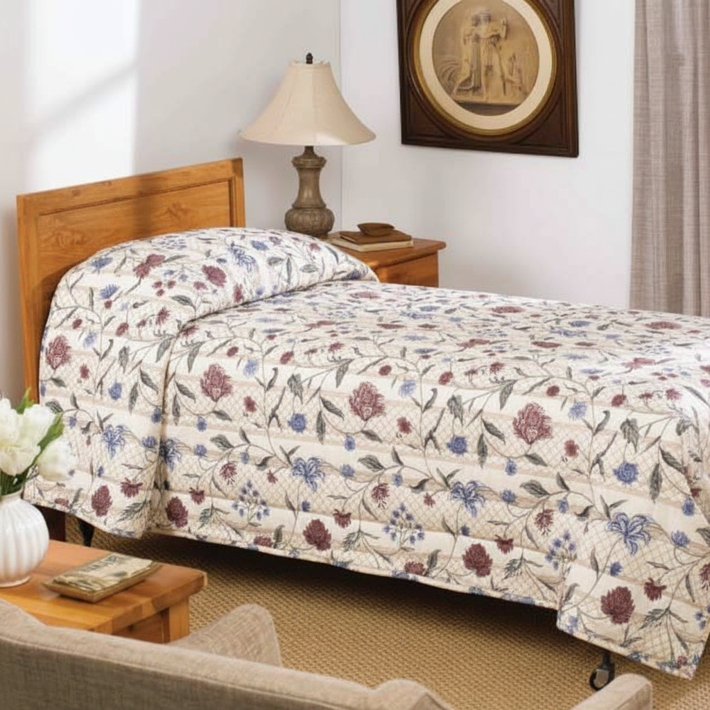 A neatly made single bed features the WestPoint Home Bedspread - Martex Mainspreads - Pattern, a cozy bedroom with a wooden headboard, nightstand and lamp, framed wall art, beige curtains, and a quilt filled with EcoPure polyester fiberfill for comfort.