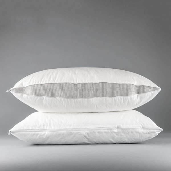 Two Martex Ultra Touch Pillow Protectors by WestPoint Home are stacked against a gray background. The top protector has a gray mesh side panel, while the bottom is solid white; both feature EcoPure fiberfill for comfort.