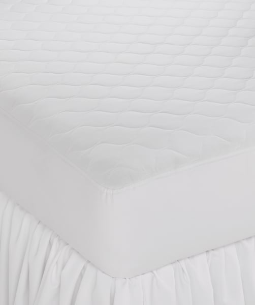 Close-up of the WestPoint Home Woven Fiber - Tough One 7.5oz Mattress Pad with anchor bands, featuring a quilted, eco-friendly design with secure fitted sides—ideal for those seeking sustainable mattress protection.