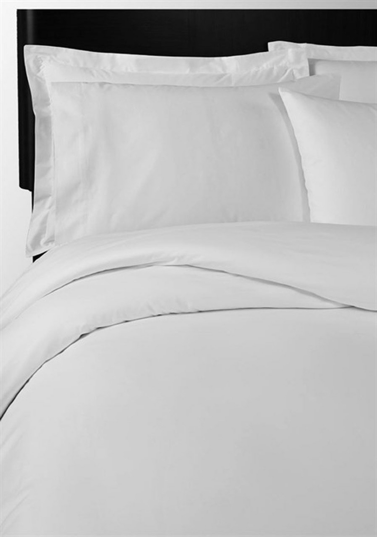 A neatly made bed with the 1Concier Flat Sheet Poly Percale T300, crisp white pillowcases, and a comforter against a dark headboard creates a clean, minimalist look thats inviting and easy to care for.