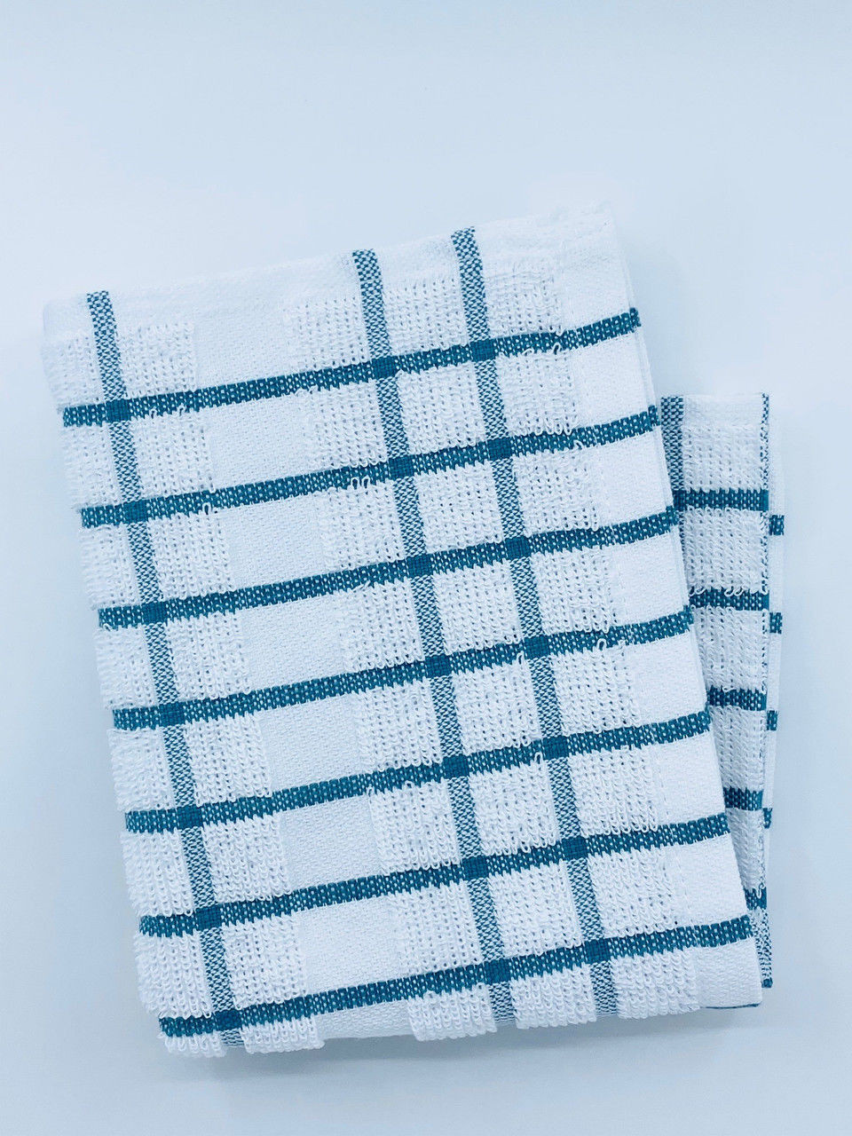 The Ganesh Mills Kitchen Towels - Colored/Checkered Pattern Oxford Kitchen Ensemble features a folded white towel with blue and black checks, made from soft ringspun cotton, displayed on a plain light background.