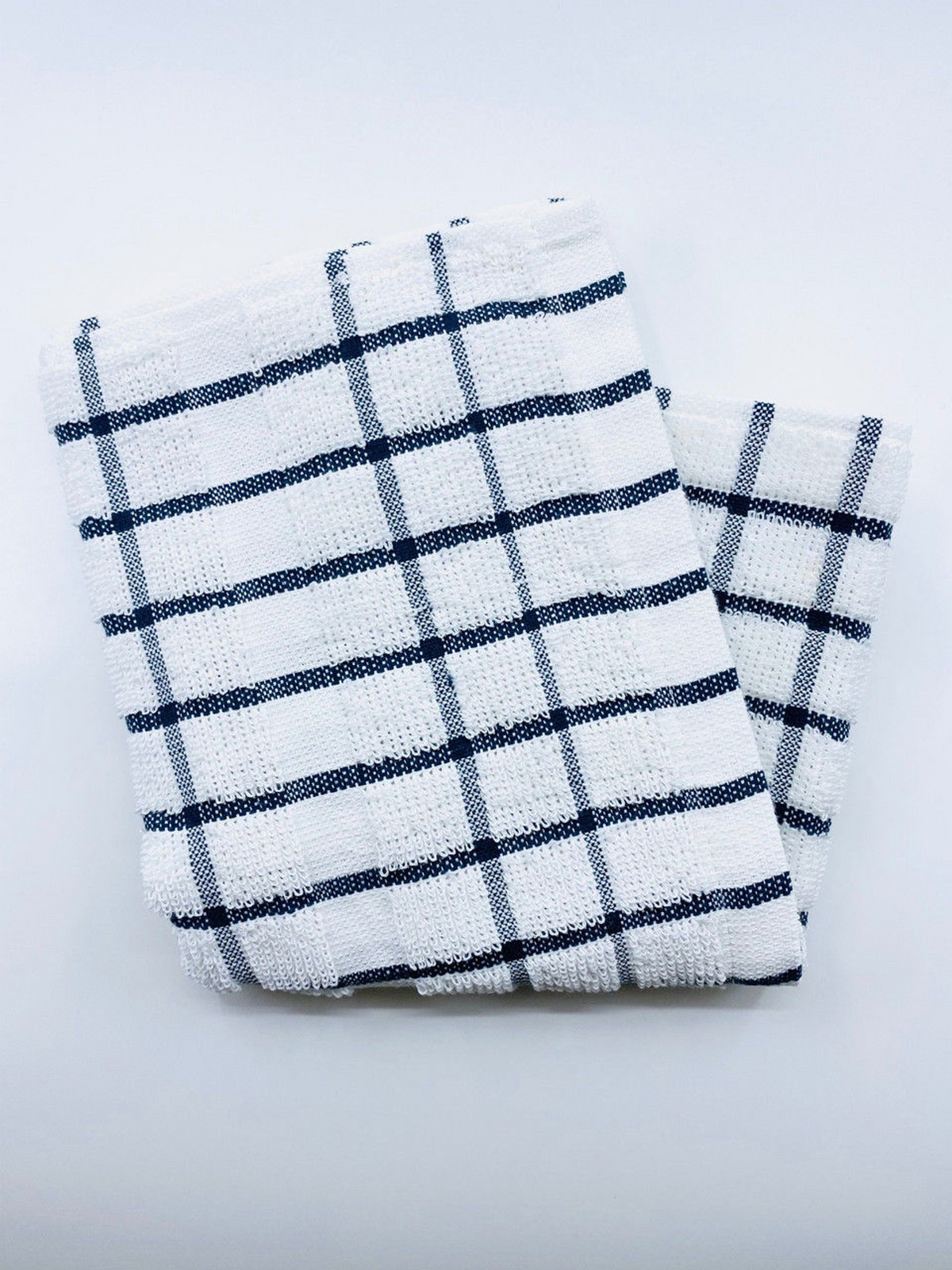 Two folded Ganesh Mills Pot Holders, part of the Oxford Kitchen Ensemble, with black and blue checkered patterns, are essential kitchen items shown on a plain white surface.