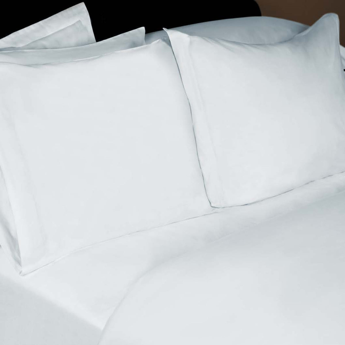 A neatly made bed with two large white pillows and Thomaston Mills Duvet Covers 200 Thread Count, offering a clean and fresh appearance.
