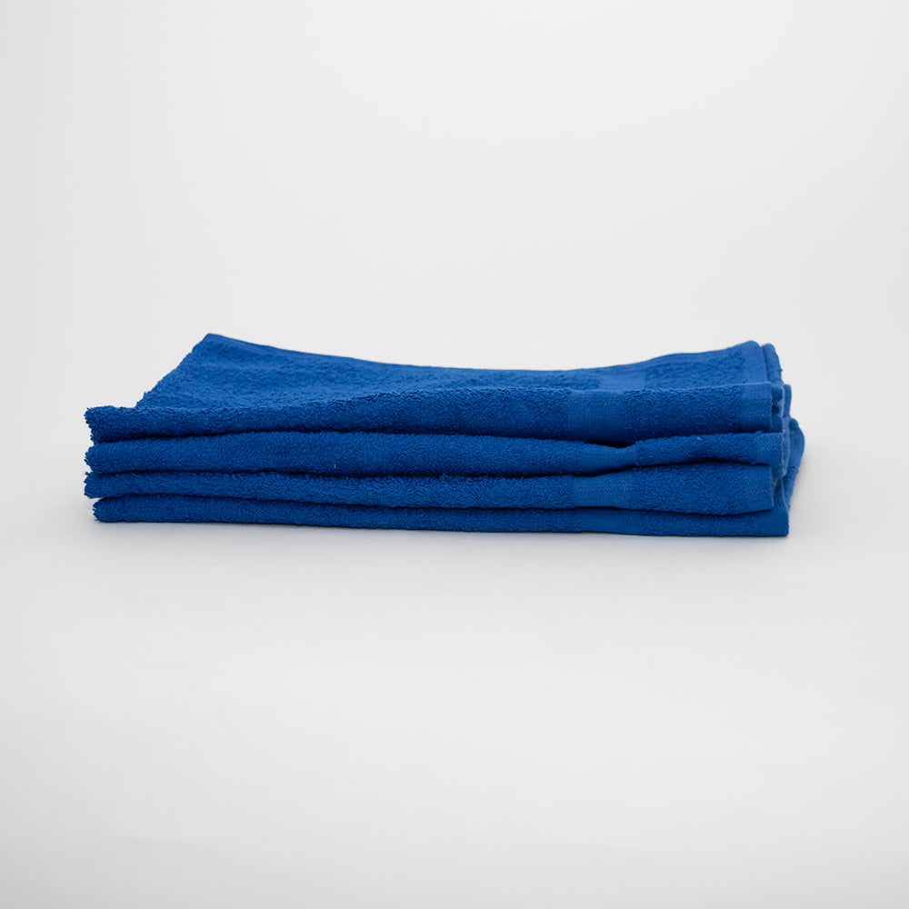A neatly folded stack of three Calderon Textiles International Hand Towels, made from 100% cotton, is placed on a plain white surface against a light gray background.