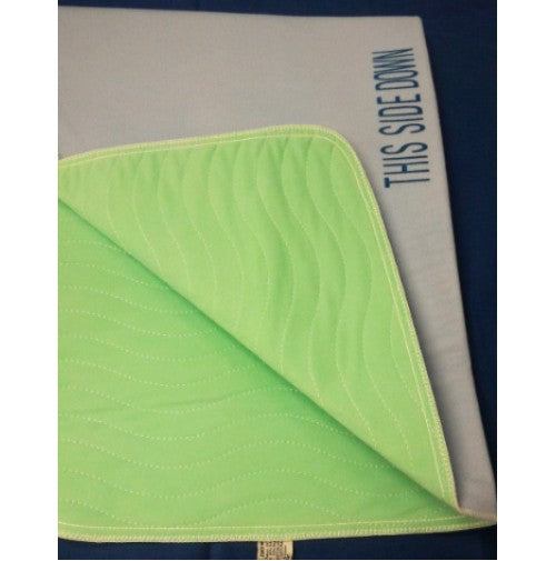 A folded green Intralin Dry-wick (PU) Bonded Incontinence Reusable Underpad, with stitched wavy lines and a gray underside marked “THIS SIDE DOWN” in blue, highlights its durability against a dark blue background.