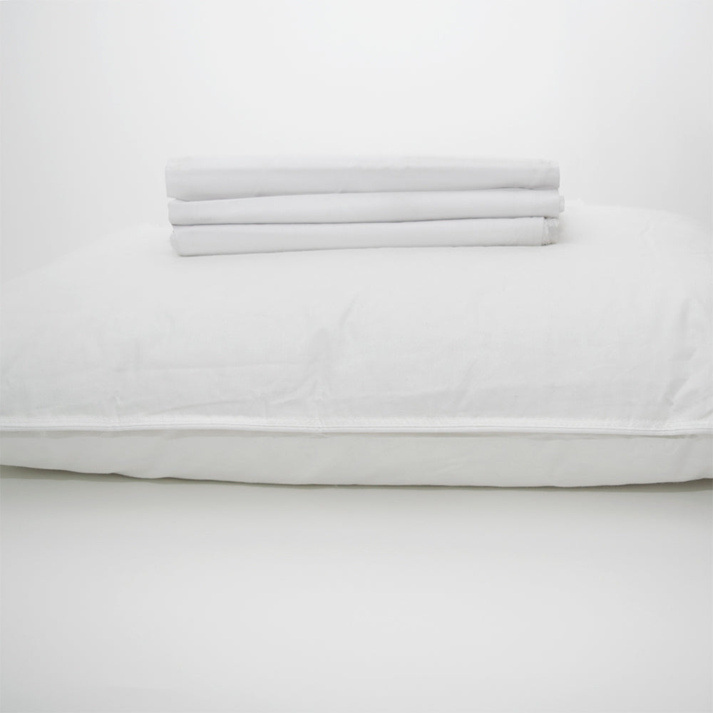 A neatly folded stack of Calderon Textiles T-130 Standard pillowcases sits atop a white background.