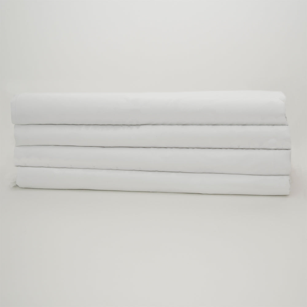 Four neatly folded Calderon Textiles Sheets Microfiber Hospital - Microtex, stacked atop each other against a plain white background.