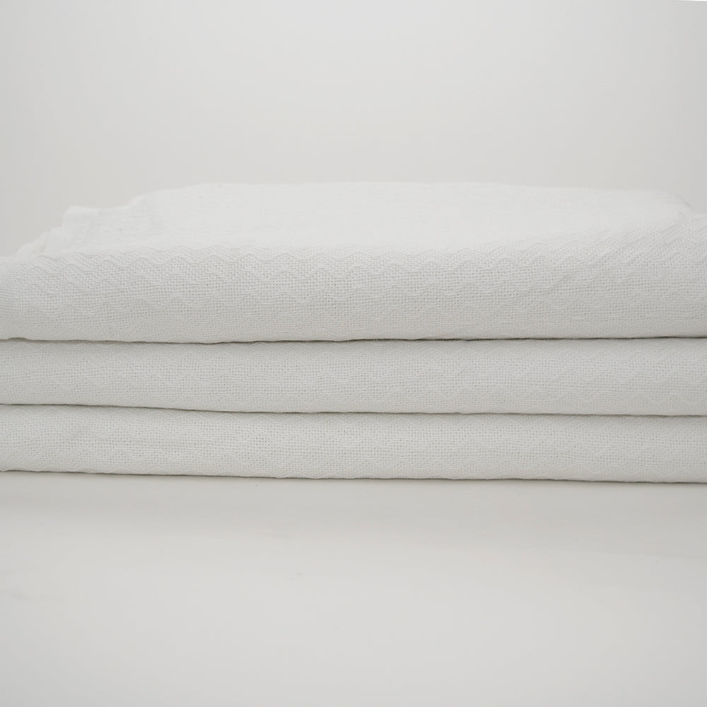 The Calderon Textiles Thermal Blanket 2.5 lbs. Bleached, shown cleanly folded against a white background, offers the practical comfort and softness ideal for everyday use.