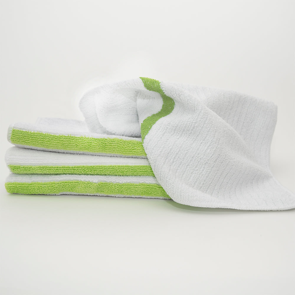 Three neatly folded Calderon Textiles Microfiber Bar Ribbed towels are stacked, one partially unfolded on top, all set against a plain white background.