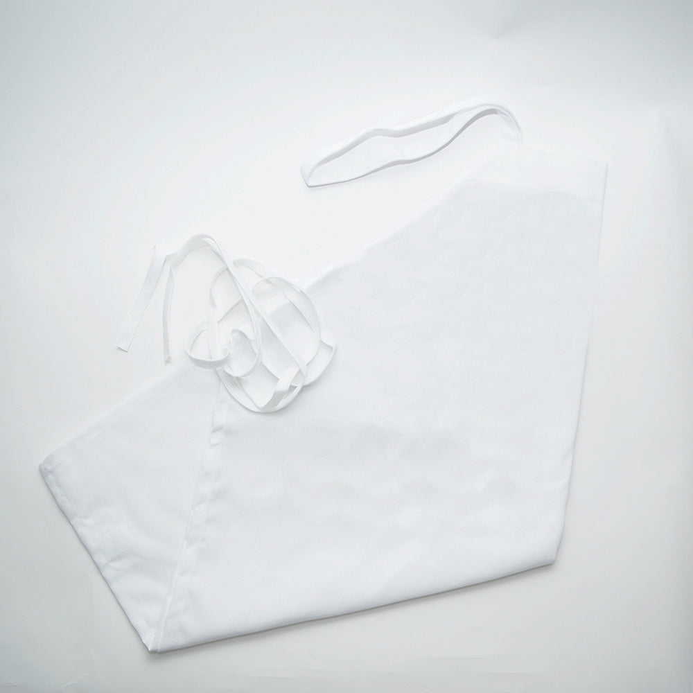 The Calderon Textiles Prisma Bib Apron, made from smooth MJS polyester, is displayed neatly folded on a white surface with long ties loosely coiled for comfort and a clean, simple appearance.