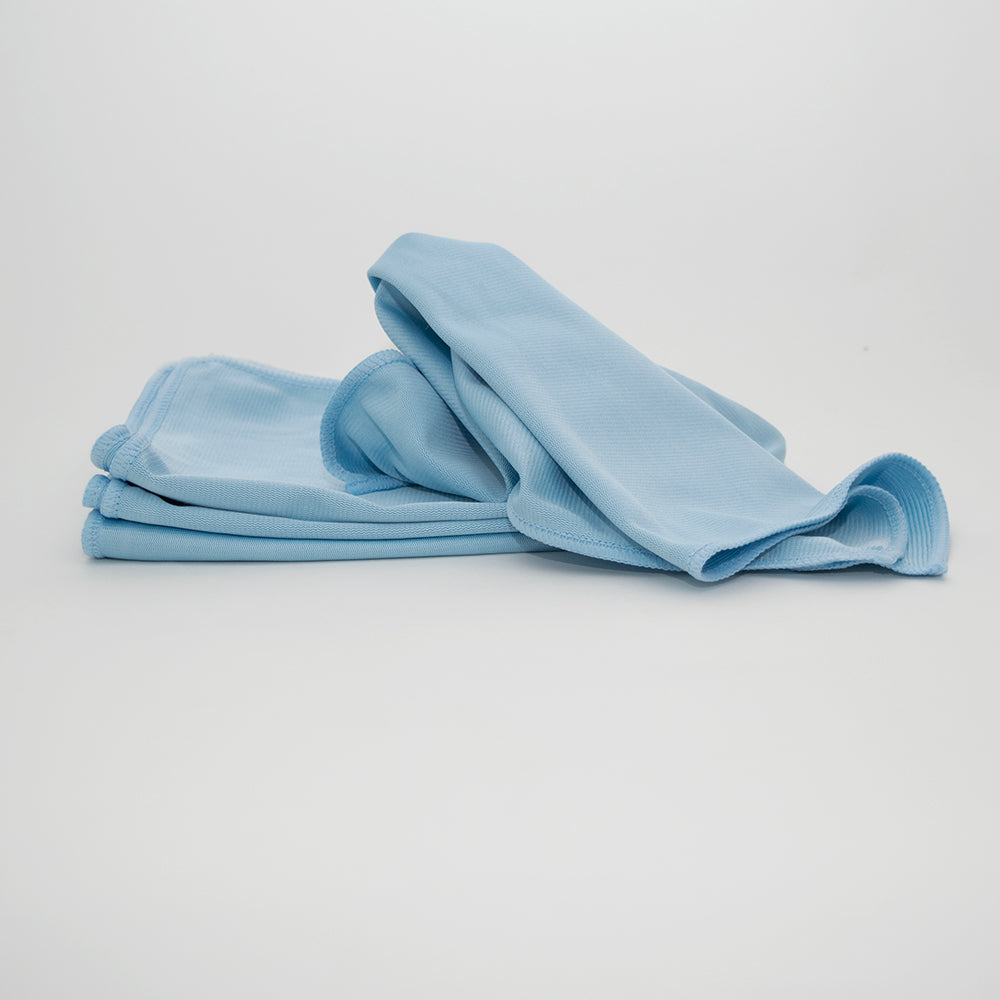 A neatly folded stack of Calderon Textiles Microfiber Tricot Glass Cloths, one partially unfolded and draped on top, is displayed against a plain white background. Ideal for reducing laundering costs.