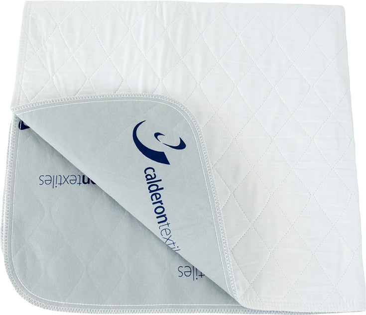 A quilted, white Calderon Textiles Underpad Brushed, Non-Slip Lining (34” x 36”) is shown partially folded to display its gray underside with blue branding. This competitively priced underpad features neat stitching.