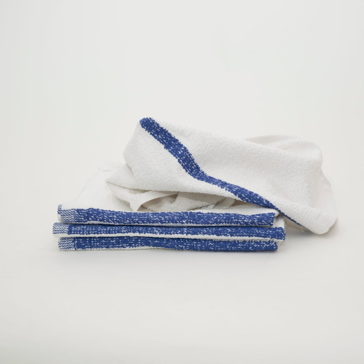A stack of four neatly folded Meridian Mop towels by Calderon Textiles with blue edges, plus one unfolded towel, all on a plain white background—an economical bar towel choice for any setting.