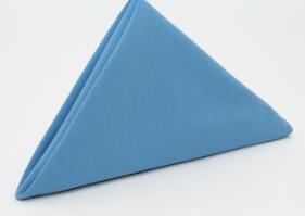 The Prisma Napkin by Calderon Textiles, featuring Color Lock dyeing technology, is neatly folded in a triangular shape and stands upright against a plain white background.