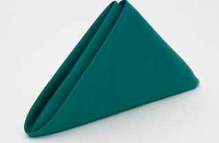 The Calderon Textiles Prisma Napkin stands upright in a neatly folded teal triangle on a white surface, offering stain resistance for easy care—ideal for stylish, practical table settings.