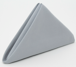 The Prisma Napkin by Calderon Textiles is neatly folded in a triangular shape against a white background, highlighting its impressive stain resistance.