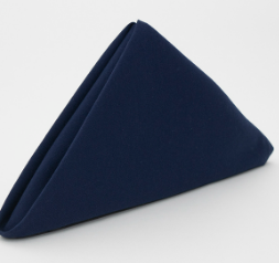 The Prisma Napkin by Calderon Textiles, in dark blue, features Color Lock dyeing for lasting durability and stain resistance. It stands upright in a triangular fold against a plain white background.
