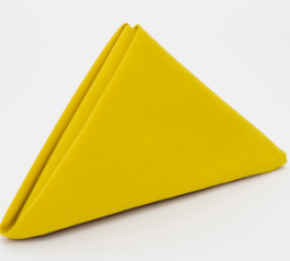 The Prisma Napkin by Calderon Textiles, folded into a yellow triangle and standing upright on a white surface, features Color Lock dyeing technology for long-lasting vibrance and durability.