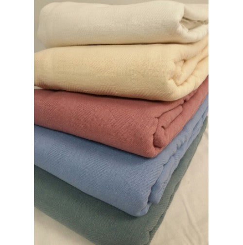 The Intralin Manchester Blended Snag-Free Blankets & Bed Spreads, in white, cream, pink, light blue, and sage green, are stacked neatly and ideal for use as cozy snag-free blankets or stylish bedspreads.