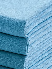 A stack of KSE Operating Room Towels in light blue, neatly folded to display their soft, textured fabric and clean edges.