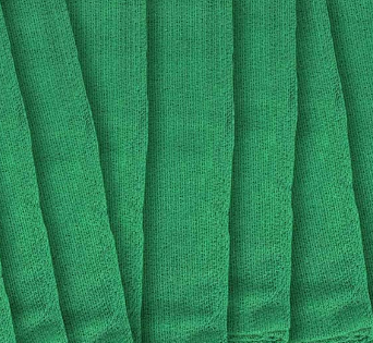 Close-up of several KSE Operating Room Towels folded side by side, showcasing their textured fabric surface and vertical pleats.
