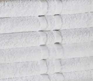 KSE Operating Room Towels are neatly stacked and uniformly folded, showcasing visible textured fabric and bands for a clean, organized look.