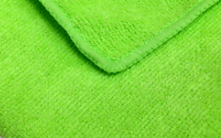 A close-up of the KSE Microfiber Cleaning Cloth highlights its bright green color, soft textured surface, and neatly stitched edge—part of our bulk microfiber cleaning cloth collection.