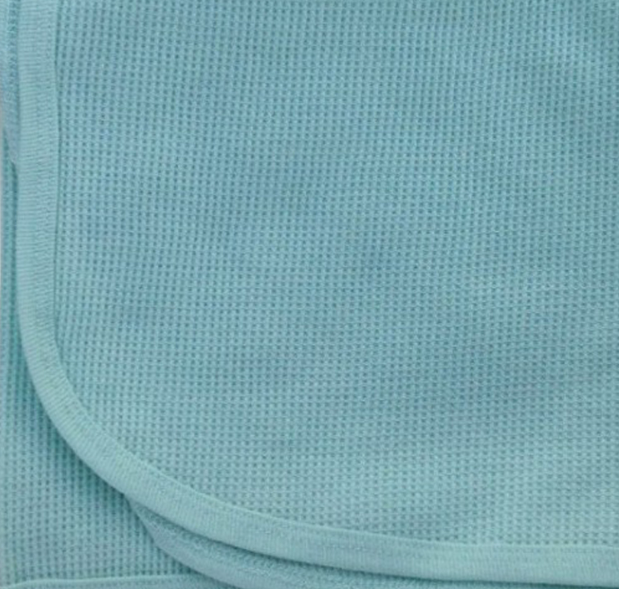 Close-up of a light blue textured fabric with rounded edges and visible stitching, suggesting it may be the KSE Baby Thermal Blanket.