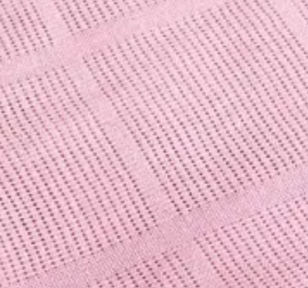 Close-up of KSE Baby Thermal Blanket’s pink, textured fabric with a grid pattern—rows of small holes and raised lines add comfort, making it ideal for babies.