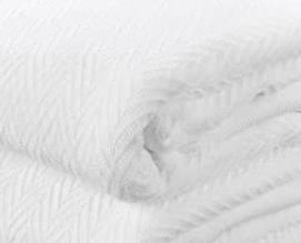 Close-up of the KSE EverLast Spread Blanket, neatly folded. The soft white fabric features a subtle chevron texture, ideal for hotel-quality comfort.