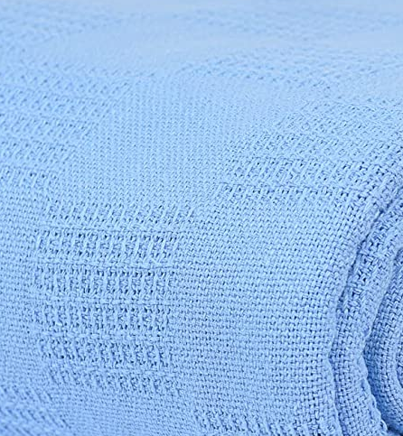 Close-up of the EverLast Spread Blanket by KSE, featuring a light blue textured polyester with a subtle checkered pattern and soft, woven look—perfect for hotel use or bulk orders.
