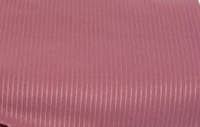 A close-up of the KSE Ribcord Bedspread in pink highlights its subtle vertical ribbed texture. Made from fire-retardant polyester, it offers style and safety—perfect for wholesale bedding collections.