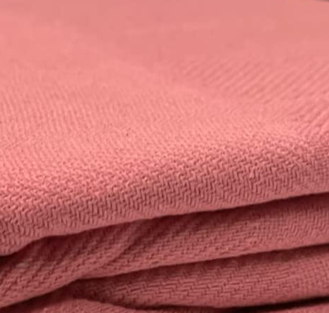 A close-up of a neatly folded pink towel showcases its soft texture and woven pattern, reminiscent of the superior quality found in KSE Snag Free Thermal Blankets.