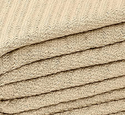 A close-up of a KSE Snag Free Thermal Blanket, neatly folded to highlight its beige herringbone weave—perfect for those wanting a durable, comfortable blanket with snag-free textured fabric.
