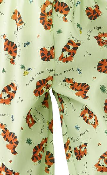The KSE Knitted Pediatric PJ Pants - Everlast feature light green fabric with playful orange and black tigers, small bugs, and scattered text like “tired little tiger” and “tiny paws”—perfect for kids’ hospital wear or pajamas.