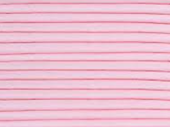 Close-up of the Ganesh Mills Oxford Hospital Bed Pads—Green/Pink—showing multiple horizontal, evenly spaced pink lines on a light pink background, forming a striped pattern typical of incontinence protection pads.