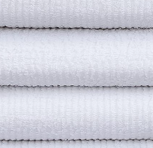 Close-up of several neatly stacked Intralin Wholesale Bar Mop Towels, highlighting their soft and textured cotton fabric.