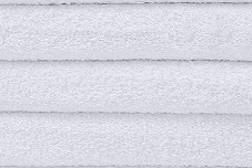 Close-up of three neatly stacked, folded white Wholesale Bar Mop Towels By Intralin, featuring a soft and fluffy texture—perfect as terry towels. Brand: Intralin.