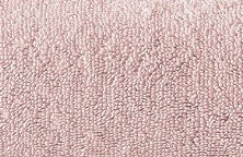 Close-up of the Spa Hand Towel by Intralin from the Spectrum Towels collection, featuring soft light pink, bumpy textured fabric with a pebble-like pattern resembling premium terry cloth.