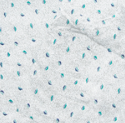 The Calderon Textiles 100% MJS Poly Patient Gown features white textured fabric with small teal and blue leaf-like patterns, subtle wrinkles, and durable construction for long-lasting beauty.