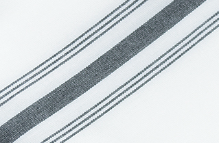 The Calderon Textiles Prisma Napkin, Inverse Stripe features a white fabric with a wide gray stripe flanked by two thin gray stripes running diagonally, ensuring excellent colorfastness and stain resistance for long-lasting durability.