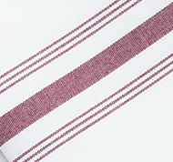 The Prisma Napkin, Inverse Stripe by Calderon Textiles features a white fabric with bold maroon diagonal stripes and is designed for excellent colorfastness to maintain lasting vibrancy.