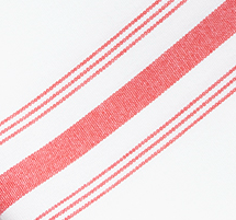 Close-up of the Prisma Napkin, Inverse Stripe by Calderon Textiles—a durable white fabric featuring a bold red diagonal stripe bordered by two thinner red lines on each side.