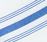 A close-up of Calderon Textiles Prisma Napkin, Inverse Stripe, shows its white fabric with blue diagonal stripes—one thick stripe bordered by thinner lines—emphasizing the napkin’s durability and stain resistance.