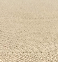 Close-up of the Bath Blanket Bleached by Calderon Textiles, featuring a textured beige surface with fine woven details and subtle horizontal lines—ideal for soft, insulating blankets.
