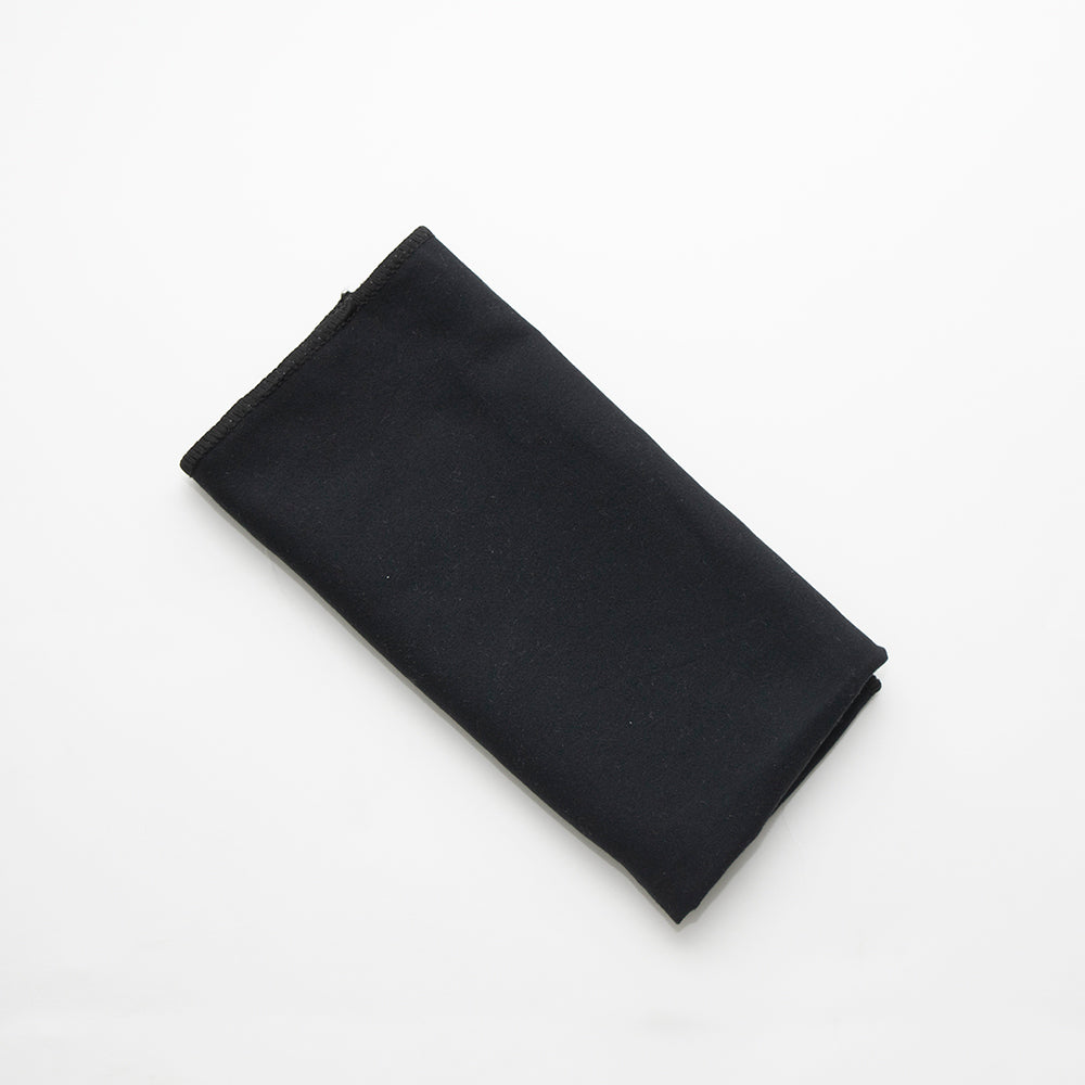 The Breeze Microfiber Napkin by Calderon Textiles, known for its wrinkle-resistant and eco-friendly properties, is showcased neatly folded on a plain white background.