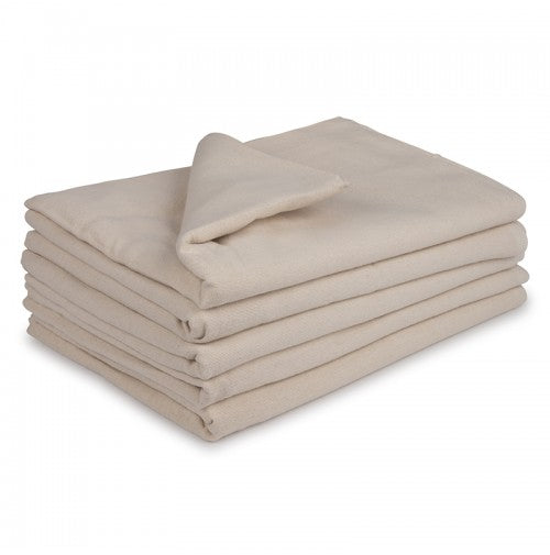 A neatly folded KSE Bath Blanket (Unbleached/White, 86% cotton/14% poly) sits on a white background with a corner turned back, showcasing its soft, thick fabric—ideal for bulk wholesale or hospital use.